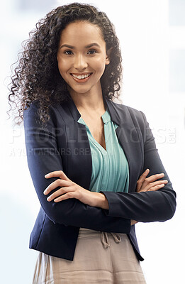 Buy stock photo Cropped portrait of an attractive young businesswoman standing with her arms folded against a white background
