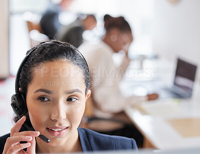 Buy stock photo Cropped shot of an attractive young female call center agent working at her desk in the office