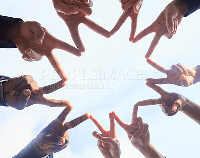 Buy stock photo Below shot of a group of unrecognizable businesspeople joining their hands against a white background