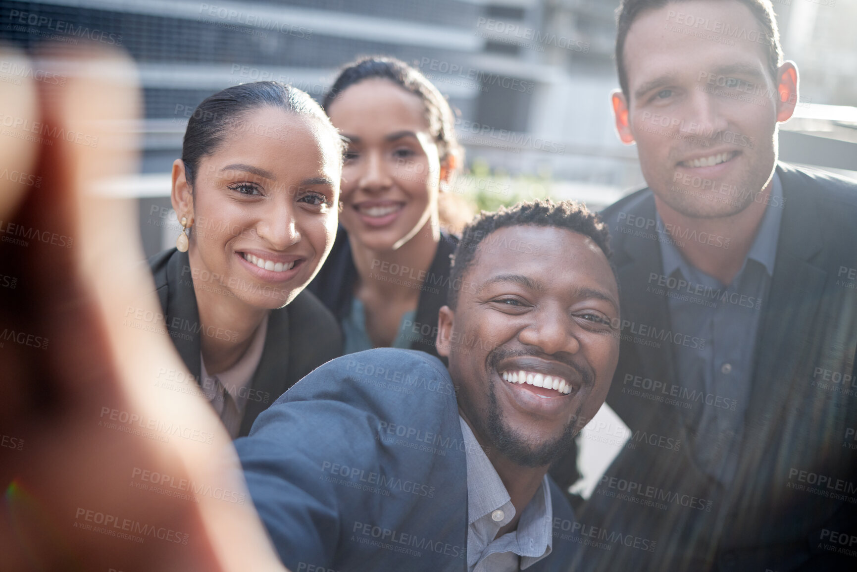 Buy stock photo Shot of a group of businesspeople taking a selfie against a city background