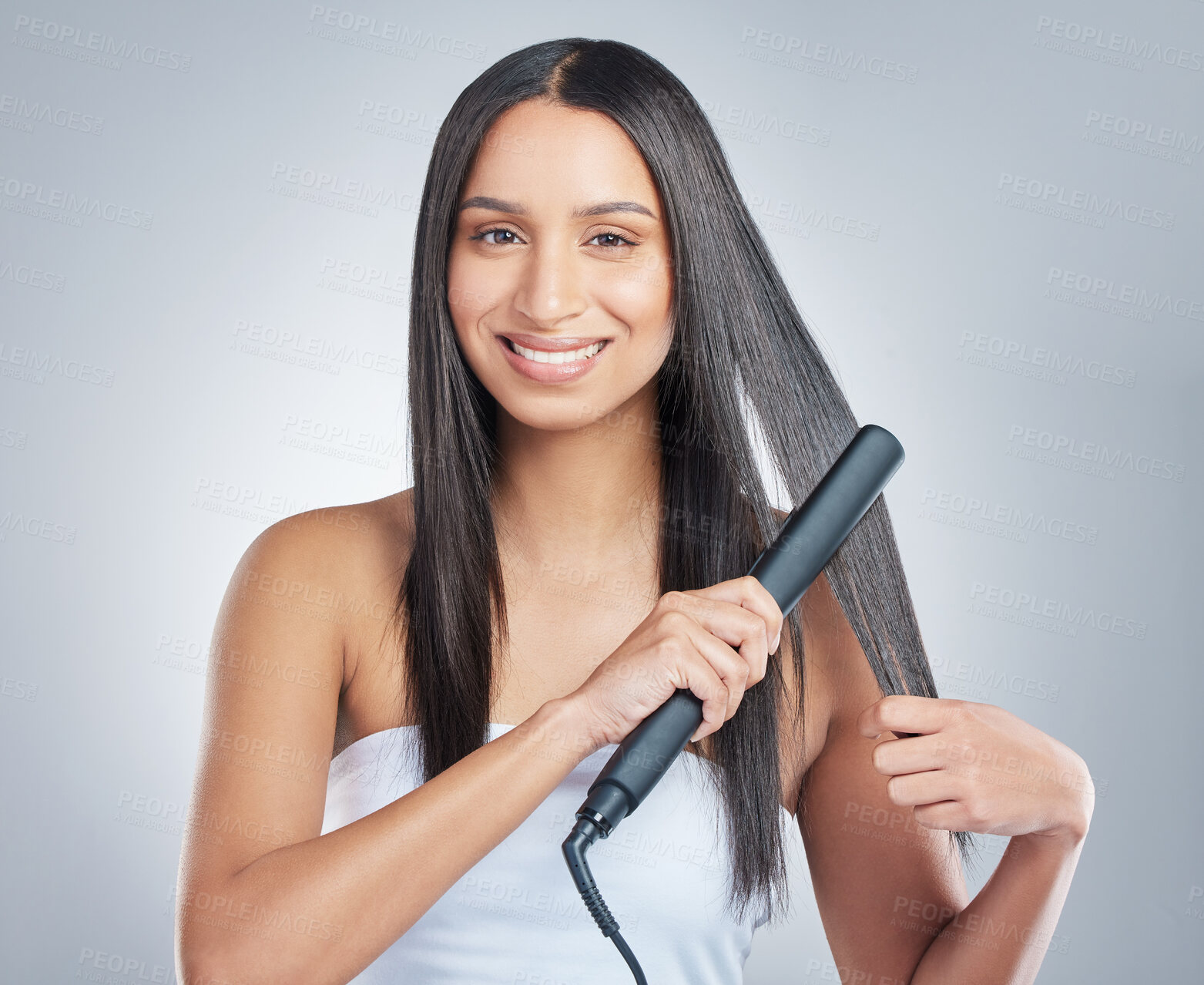 Buy stock photo Portrait, beauty and happy woman with hair straightener in studio for style, treatment and shampoo shine results on grey background. Haircare, flat iron and model face with smooth, texture or growth