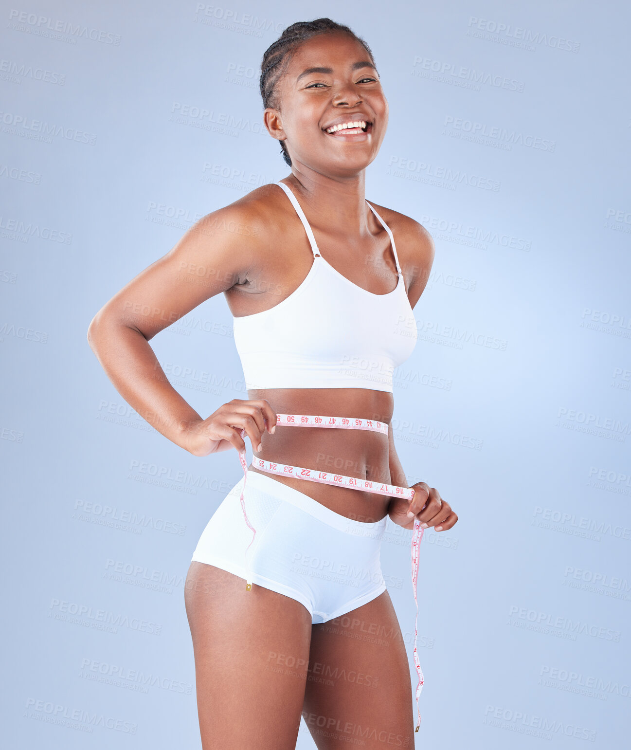 Buy stock photo Happy black woman, portrait and waist with measuring tape for weight loss on a blue studio background. African female person or young model with smile for diet, fitness or slim body from nutrition