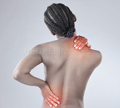 Buy stock photo Rearview shot of a woman experiencing shoulder and back pain