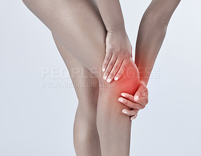 Buy stock photo Studio shot of a woman suffering from a knee injury