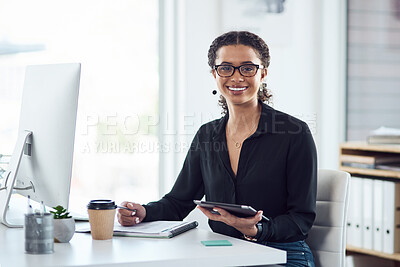 Buy stock photo Portrait of a young businesswoman writing notes while using a digital tablet and computer in an office