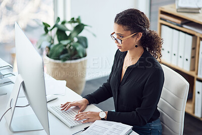 Buy stock photo High angle shot of a young businesswoman working on a computer in an office