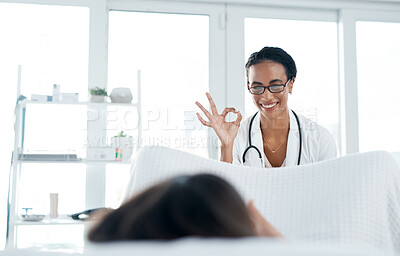 Buy stock photo Shot of a young gynecologist giving her patient an exam
