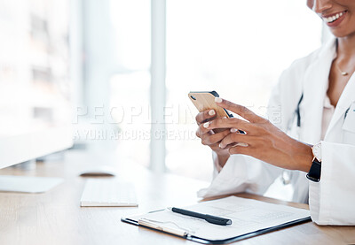 Buy stock photo Shot of a female doctor using her smartphone to send a text