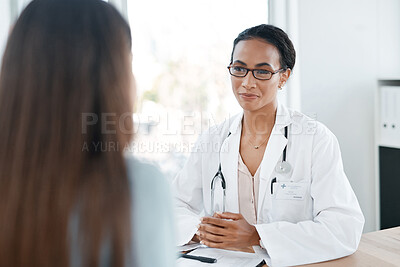 Buy stock photo Shot of a young doctor talking to her patient