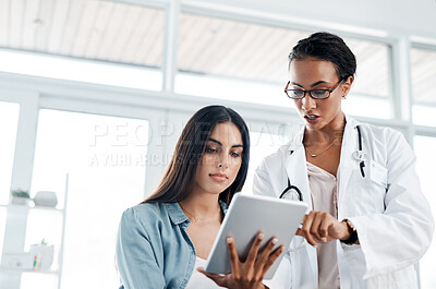 Buy stock photo Shot of a doctor showing a patient her test results on a digital tablet