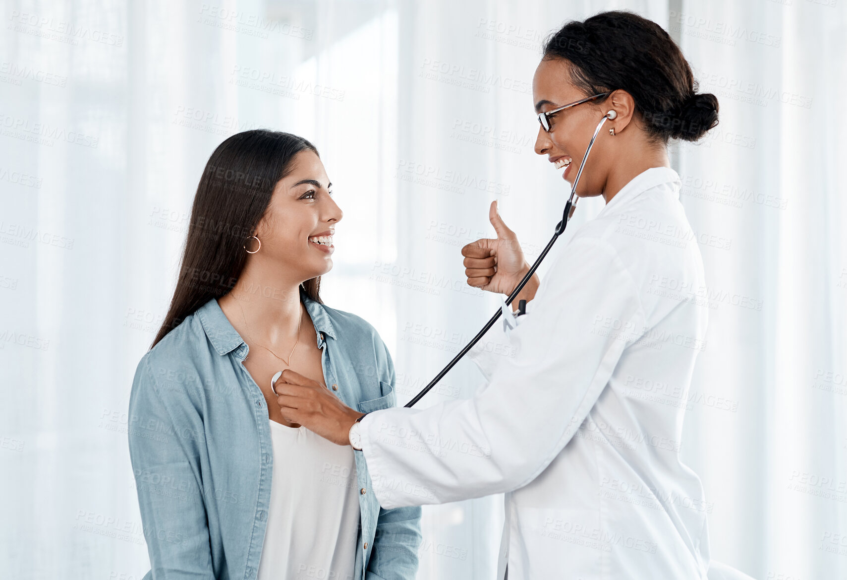 Buy stock photo Thumbs up, patient and doctor with stethoscope in consultation, diagnosis or prescription. Female people, healthcare and examination for symptoms, support and heartbeat in hospital or wellness clinic