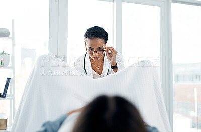 Buy stock photo Shot of a female doctor giving a patient a gynecological checkup
