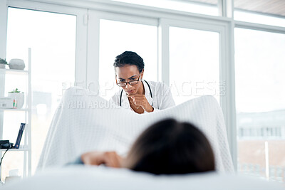Buy stock photo Shot of a female doctor giving a patient a gynecological checkup