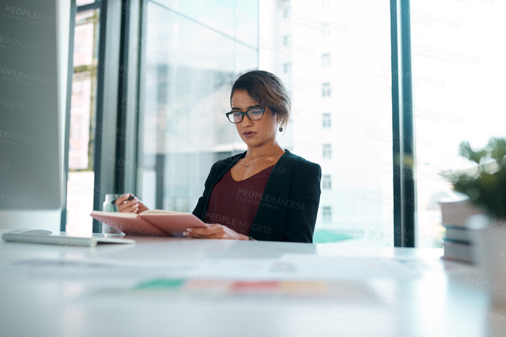 Buy stock photo Serious, woman and office with writing on journal for business agenda, notes and information in table. Female person, employee and planning as graphic designer for creativity, ideas and vision