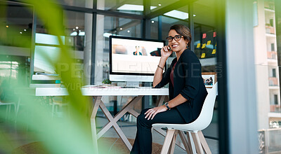 Buy stock photo Shot of an attractive young businesswoman sitting alone at her desk in the office