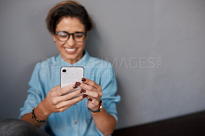 Buy stock photo Hands, smartphone and happy woman by wall for funny text, meme or update on social media. Scrolling, cellphone and female influencer with glasses for joke, comedy and humor story on online platform