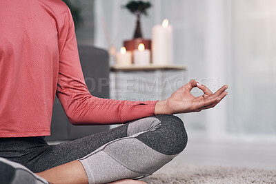 Buy stock photo Shot of an unrecognizable woman meditating on the lounge floor home