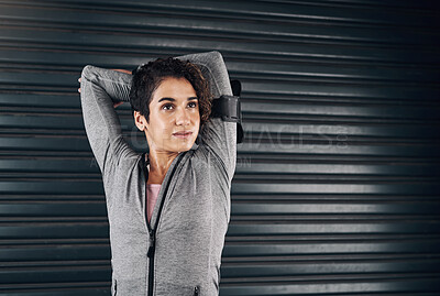 Buy stock photo Shot of a young woman doing some warmup stretches before exercising outside against a black background