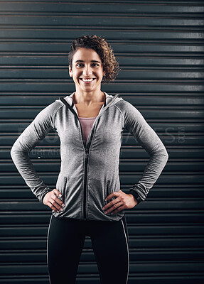 Buy stock photo Portrait of a young beautiful woman posing with her hands on her hips against a black background