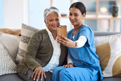 Buy stock photo Cropped shot of an attractive young female nurse taking selfies with a senior patient
