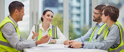 Buy stock photo Cropped shot of a group of young construction workers sitting around the boardroom table during a meeting