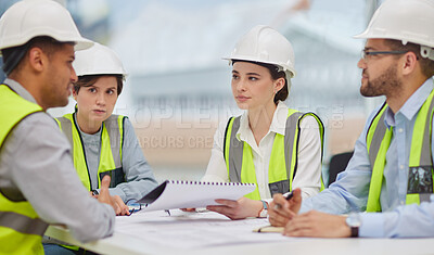 Buy stock photo Cropped shot of a group of young construction workers sitting around the boardroom table during a meeting