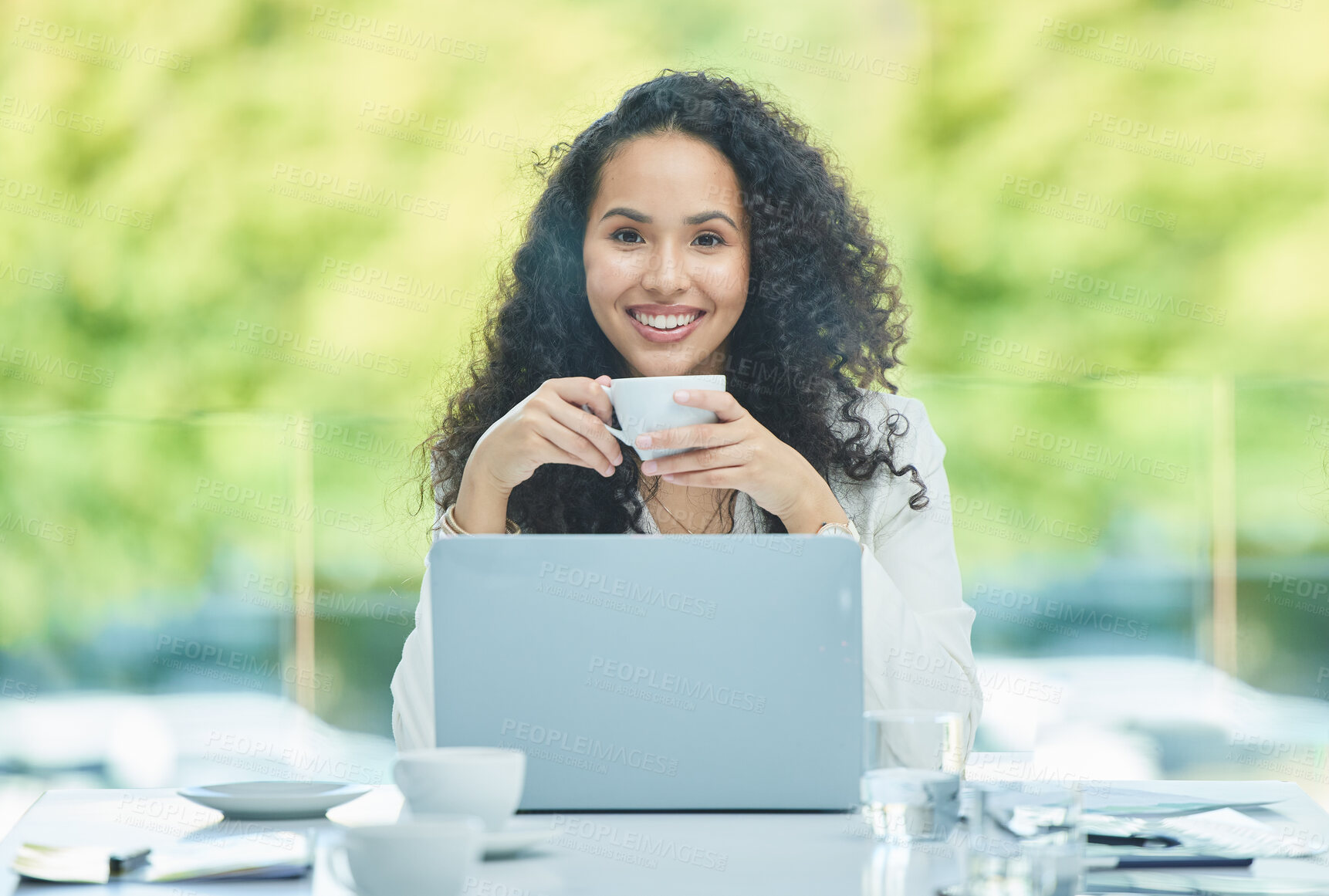 Buy stock photo Shot of a young businesswoman drinking a cup of coffee while sitting at her desk