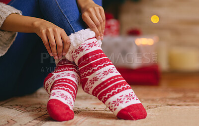 Buy stock photo Christmas, socks and feet of person in home with cozy, comfortable and warmth for traditional festival. Winter, house and legs relax on floor in living room for holiday, vacation and festive event