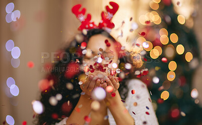 Buy stock photo Woman, Christmas and blowing confetti for holiday celebration in home, sparkle or glitter. Female person, bokeh and festive season for winter break or xmas vacation with tree lights, fun or party