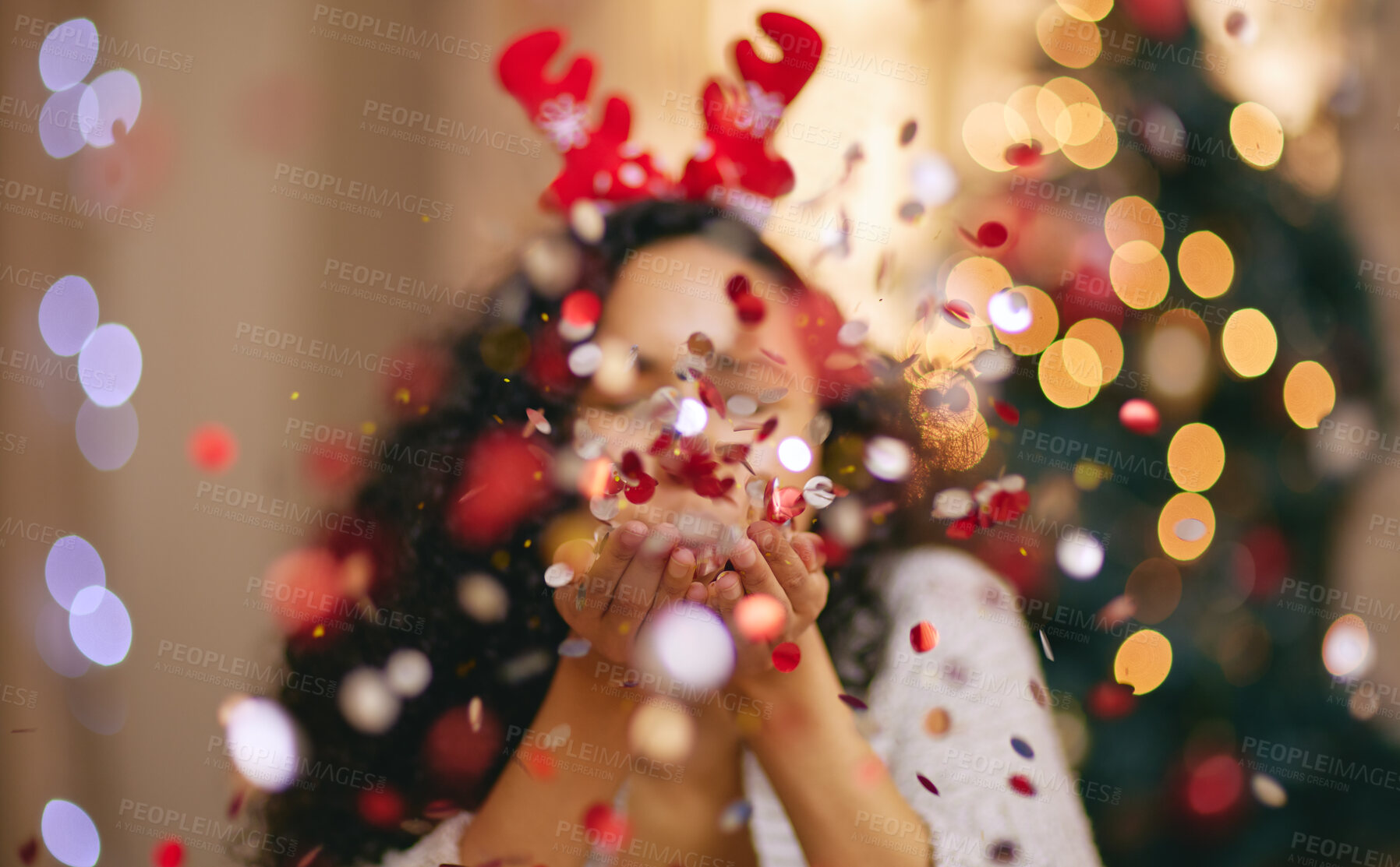 Buy stock photo Woman, Christmas and blowing confetti for holiday celebration in home, sparkle or glitter. Female person, bokeh and festive season for winter break or xmas vacation with tree lights, fun or party