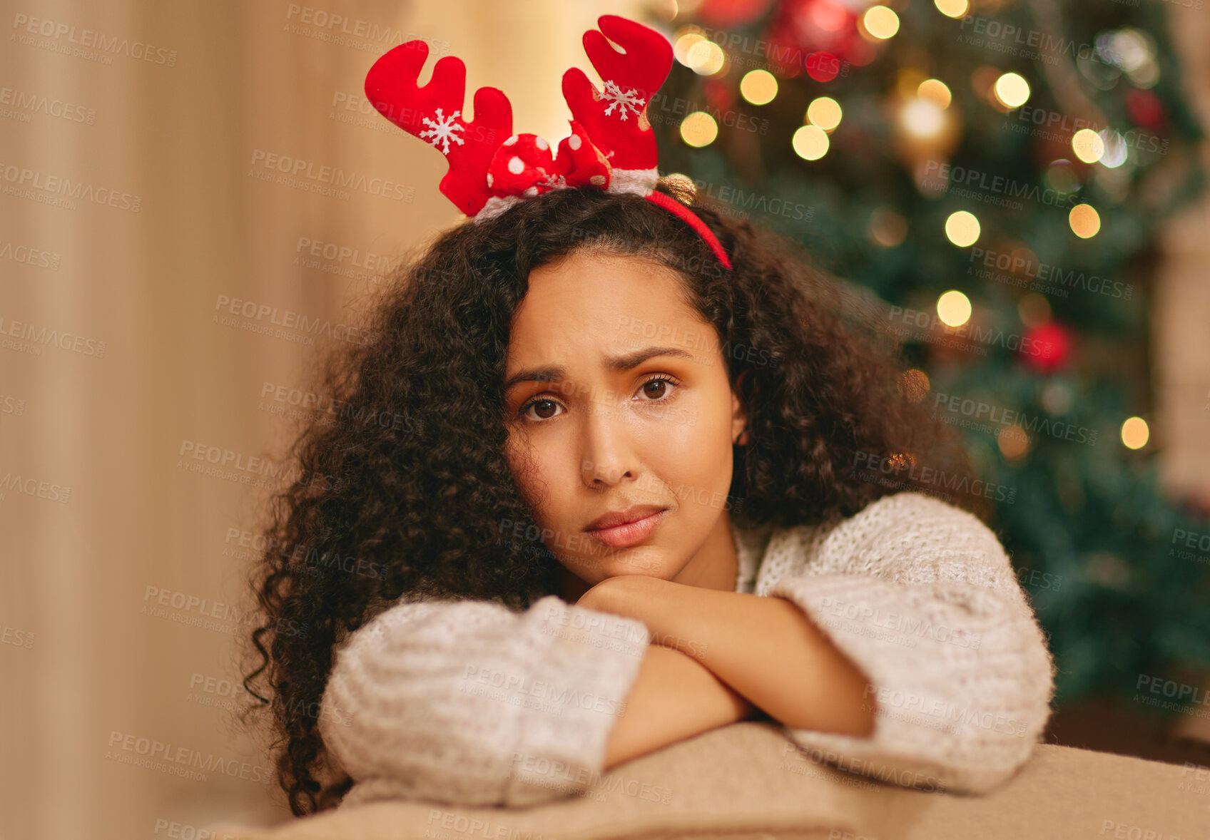 Buy stock photo Portrait, lonely and sad woman on couch at Christmas with crisis, frustrated face and holiday in lounge at home. Mental health, vacation and girl with depression on sofa in living room with xmas tree