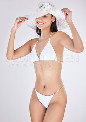 Buy stock photo Studio portrait of an attractive young woman posing in a bikini against a grey background