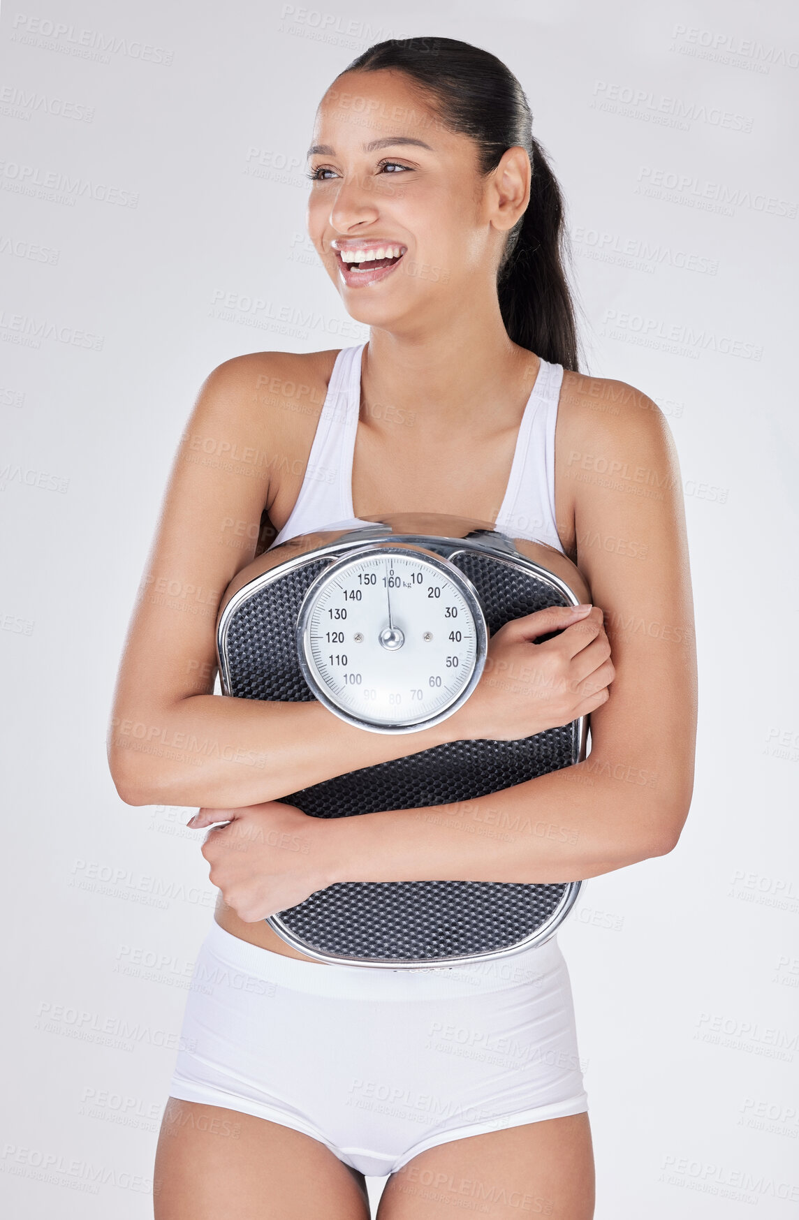 Buy stock photo Girl, laugh and scale in studio for weight loss, smile and excited for results of diet or detox. Female person, underwear and happy for calories burned target or goals, wellness and white background