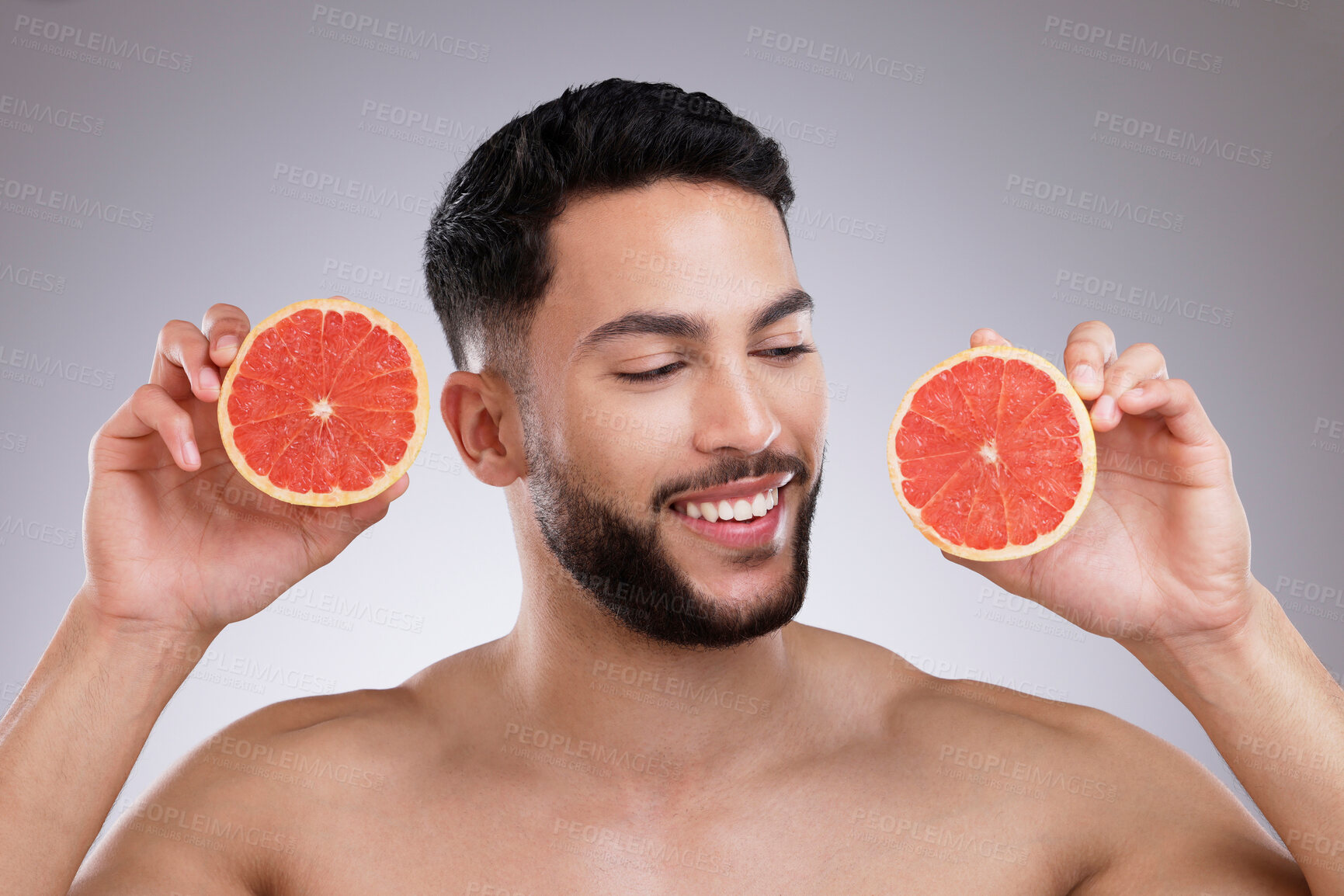 Buy stock photo Studio, smile and man with grapefruit, skincare and natural confidence, vitamin c and citrus. Cosmetics, facial health and happy male model with fruit, dermatology or grooming on white background