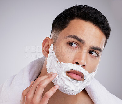 Buy stock photo Shaving, cream and foam with face of man in studio for hair removal, beauty and skincare. Cosmetics, self care and morning with model and beard grooming on gray background for cleaning and product