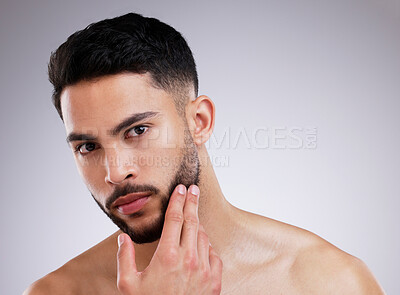 Buy stock photo Portrait, skincare and natural beauty of man grooming in studio isolated on white background. Dermatology, touch face and serious model in cosmetics for health, wellness or clean facial aesthetic