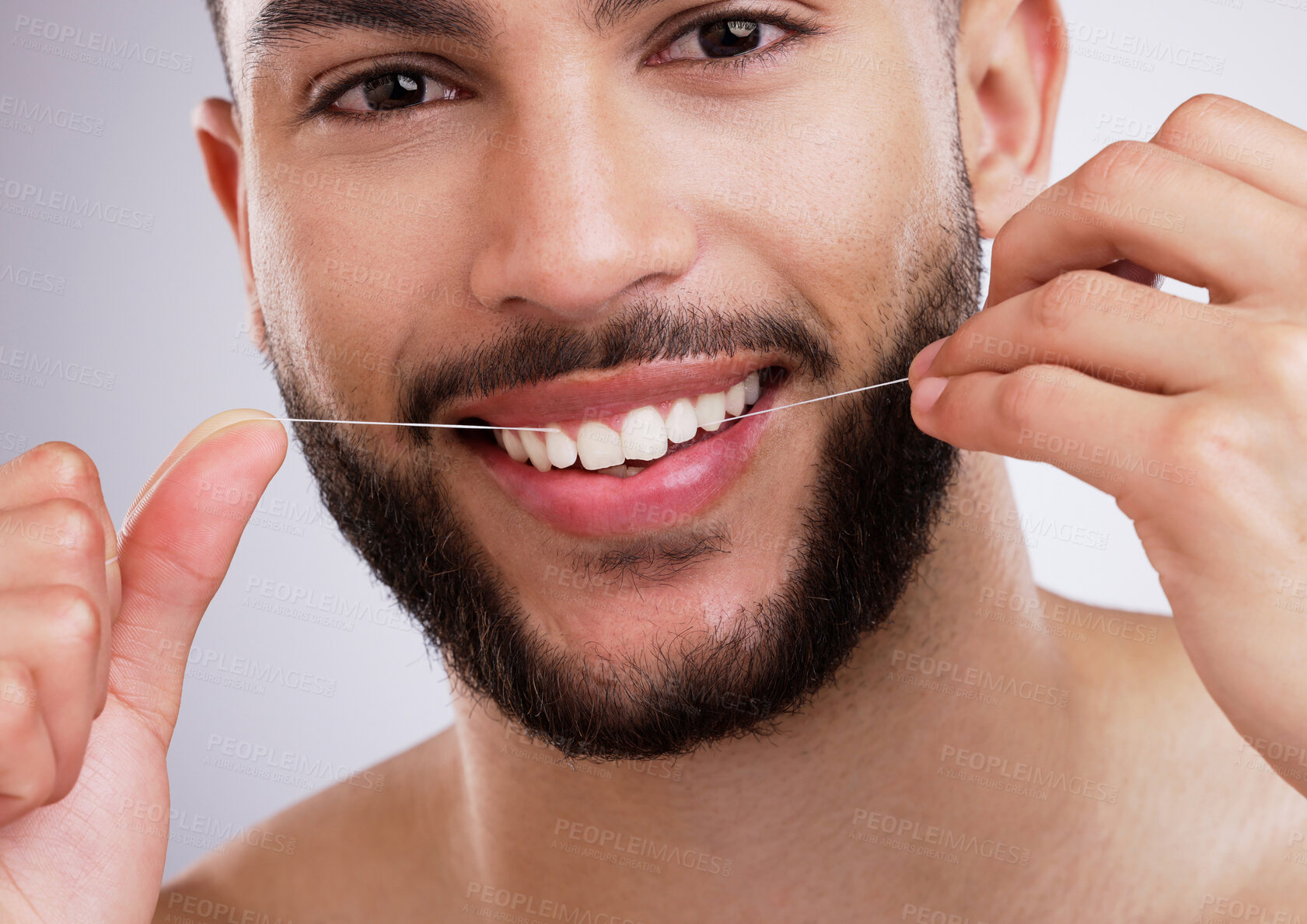 Buy stock photo Studio, portrait and man with floss, smile and dental care with confidence, protection and grooming. Mouth, health and happy male model cleaning teeth, gums and routine isolated on grey background.