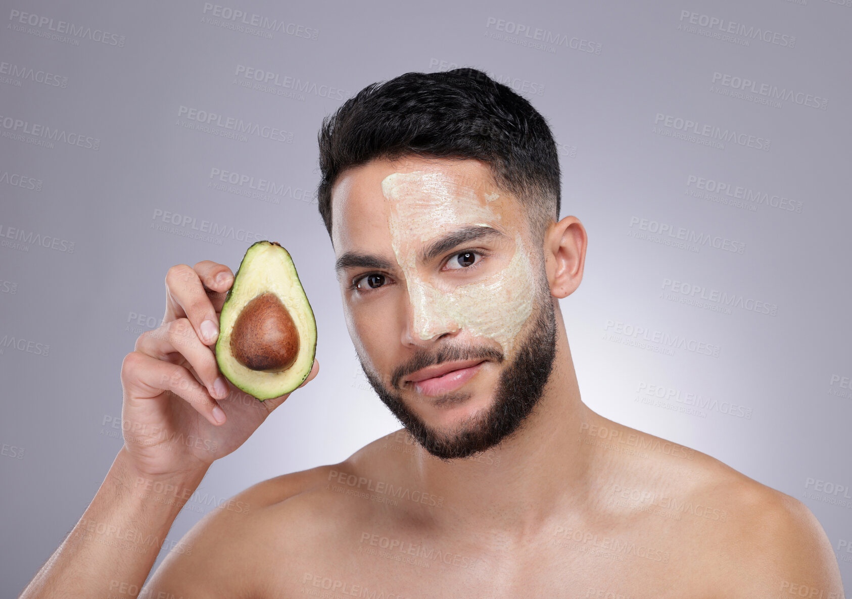 Buy stock photo Skincare, portrait and man with avocado mask, confidence and vitamin c treatment in studio. Cosmetics, facial health and happy male model with fruit detox, dermatology or grooming on grey background