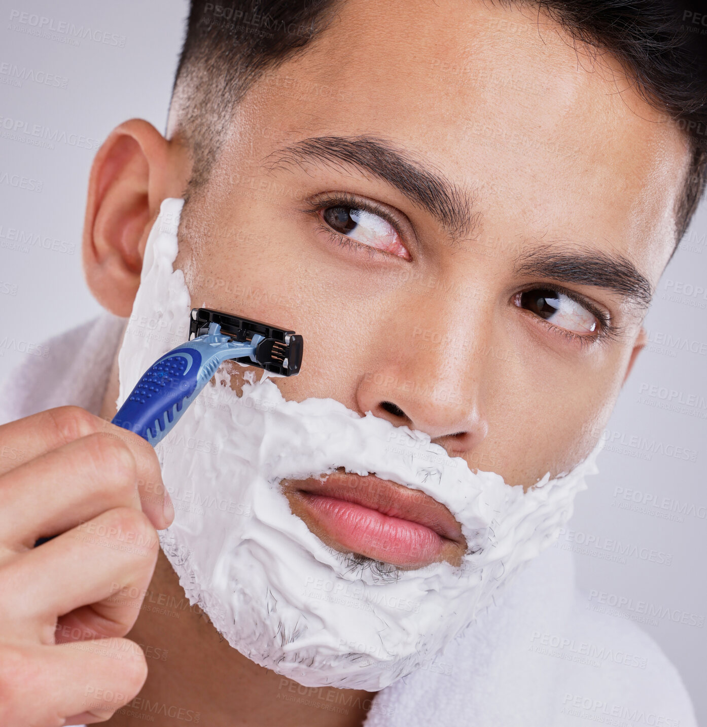 Buy stock photo Beard, shaving and foam with man and razor in studio for hair removal, grooming and skincare. Cosmetics, self care and morning with face of model on gray background for cleaning and shaver product