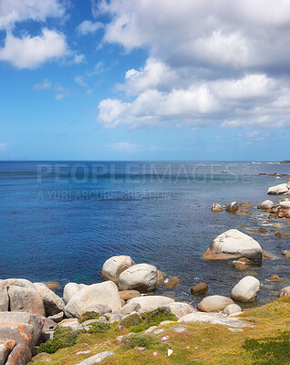 Buy stock photo Scenic ocean view of beach with rocks or boulders and sea water washing onto shore during peaceful summer vacation in tropical resort and island overseas. Rough texture and detail of rocky coastline