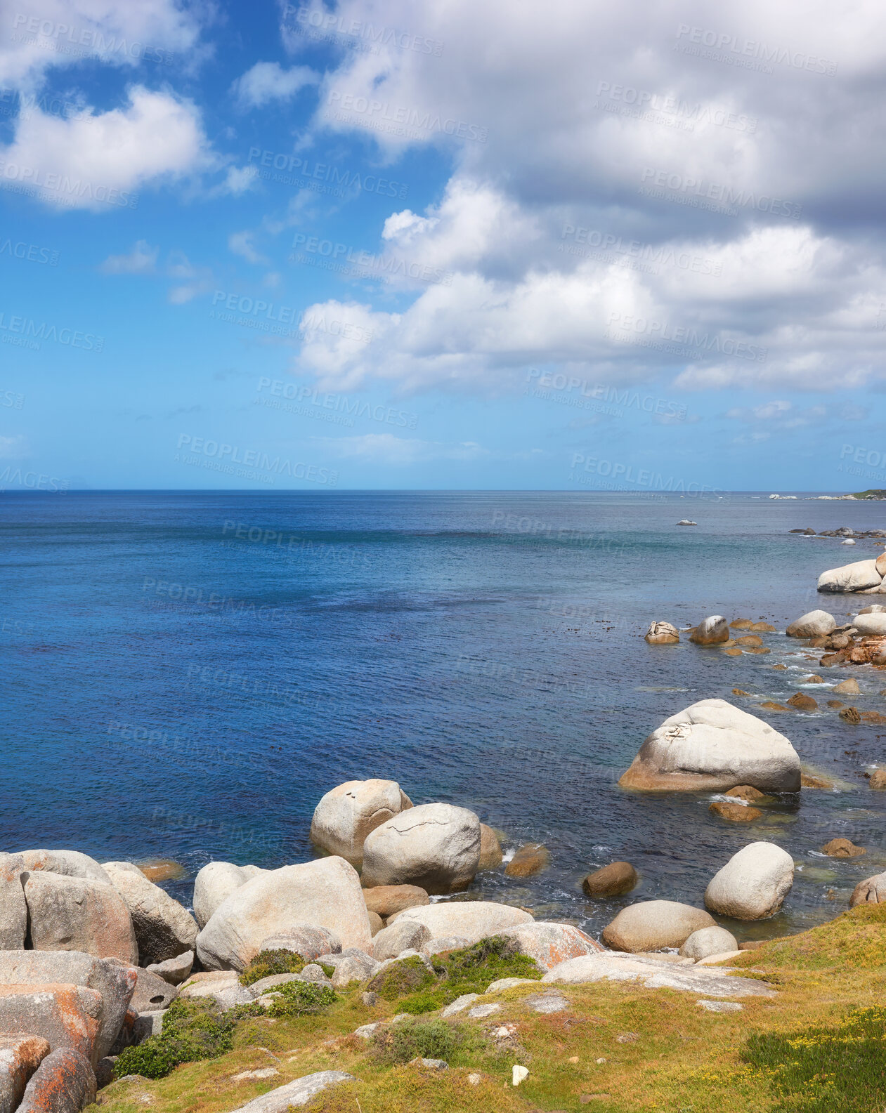 Buy stock photo Scenic ocean view of beach with rocks or boulders and sea water washing onto shore during peaceful summer vacation in tropical resort and island overseas. Rough texture and detail of rocky coastline