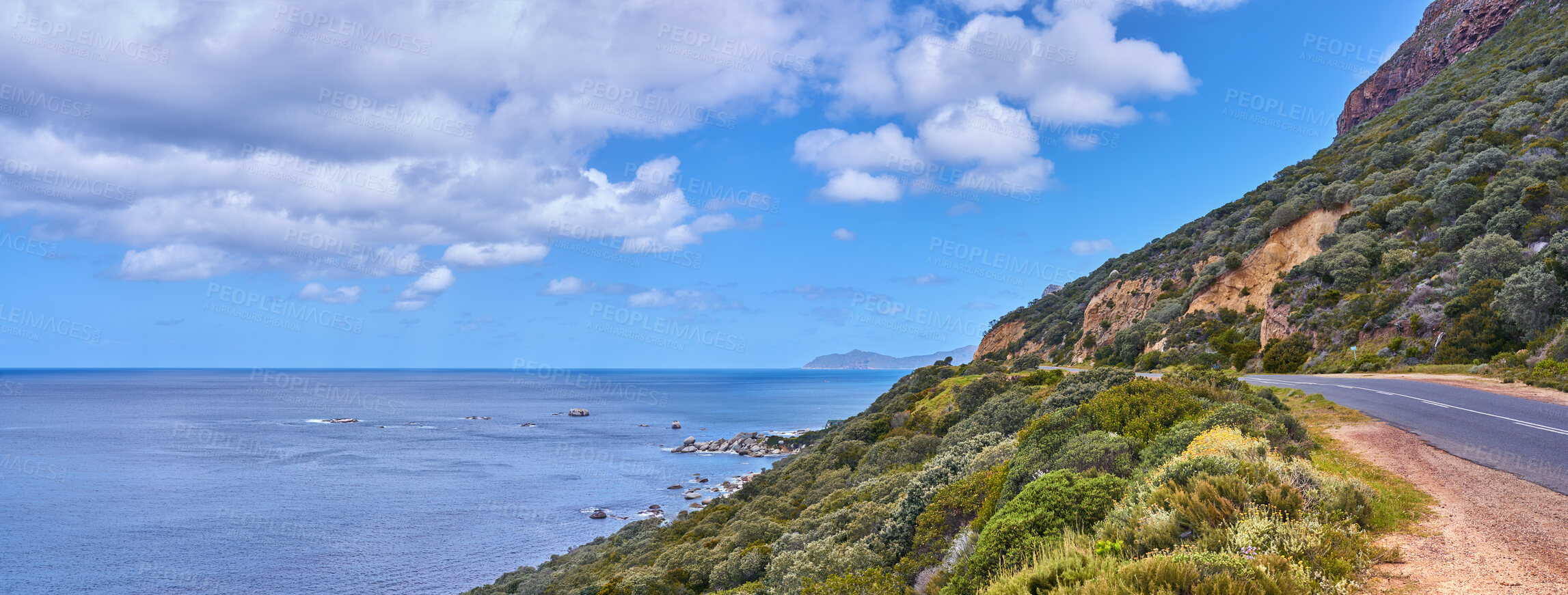 Buy stock photo Copy space with sea view and a street along the mountain against a cloudy sky background at the coast. Beautiful and scenic coastal landscape of nature to travel or explore on a peaceful road trip