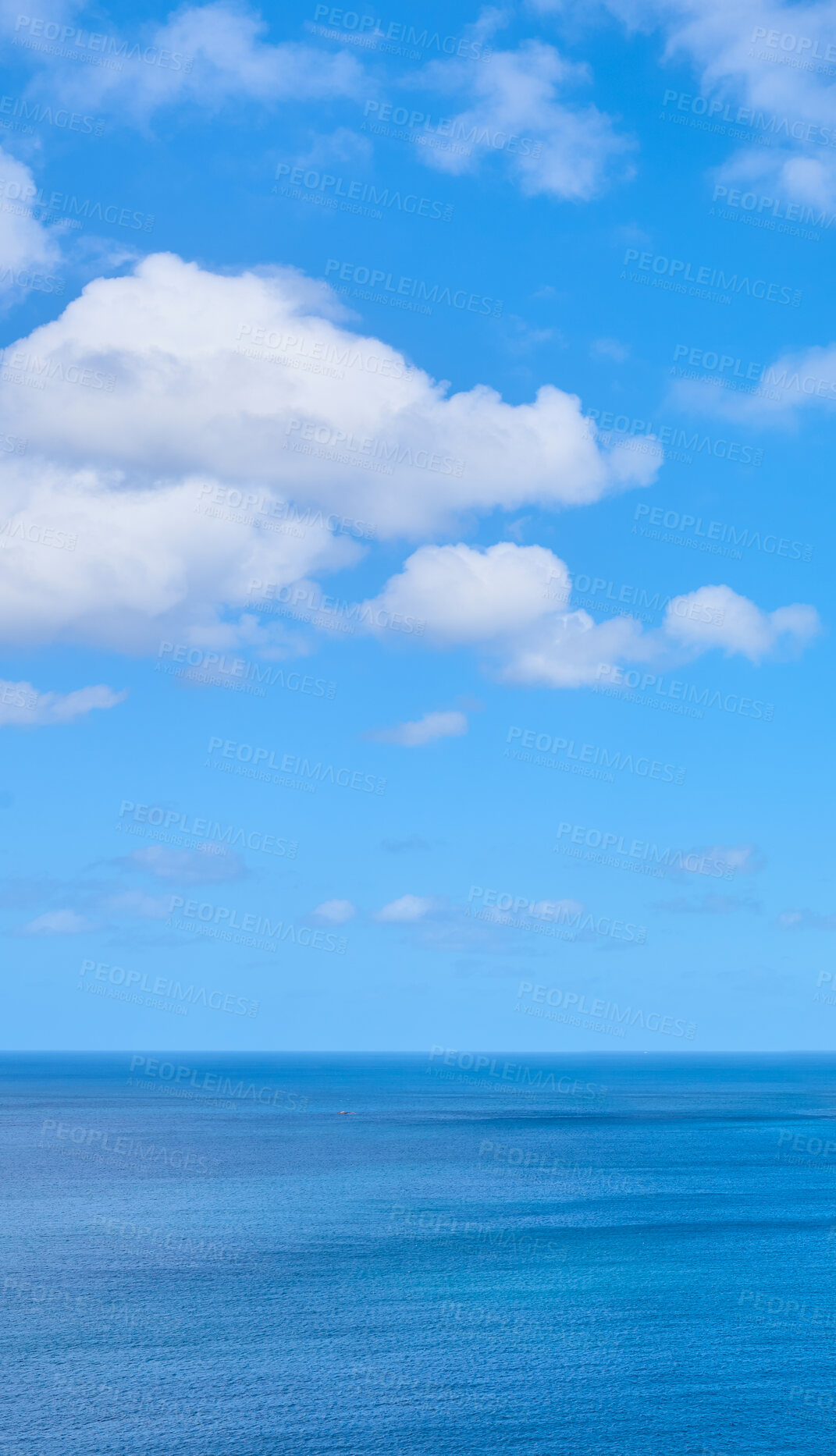Buy stock photo Copy space at the sea with a cloudy blue sky background above the horizon. Panoramic of calm ocean waters across a beach shore. Peaceful scenic coastal landscape for a relaxing and zen summer getaway