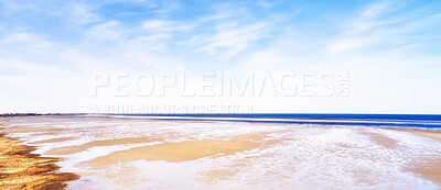 Buy stock photo Beautiful landscape scenic view of the beach and water against a cloudy blue sky in summer. Copyspace and banner view of the seaside and ocean. Natural environment of the sea with copy space