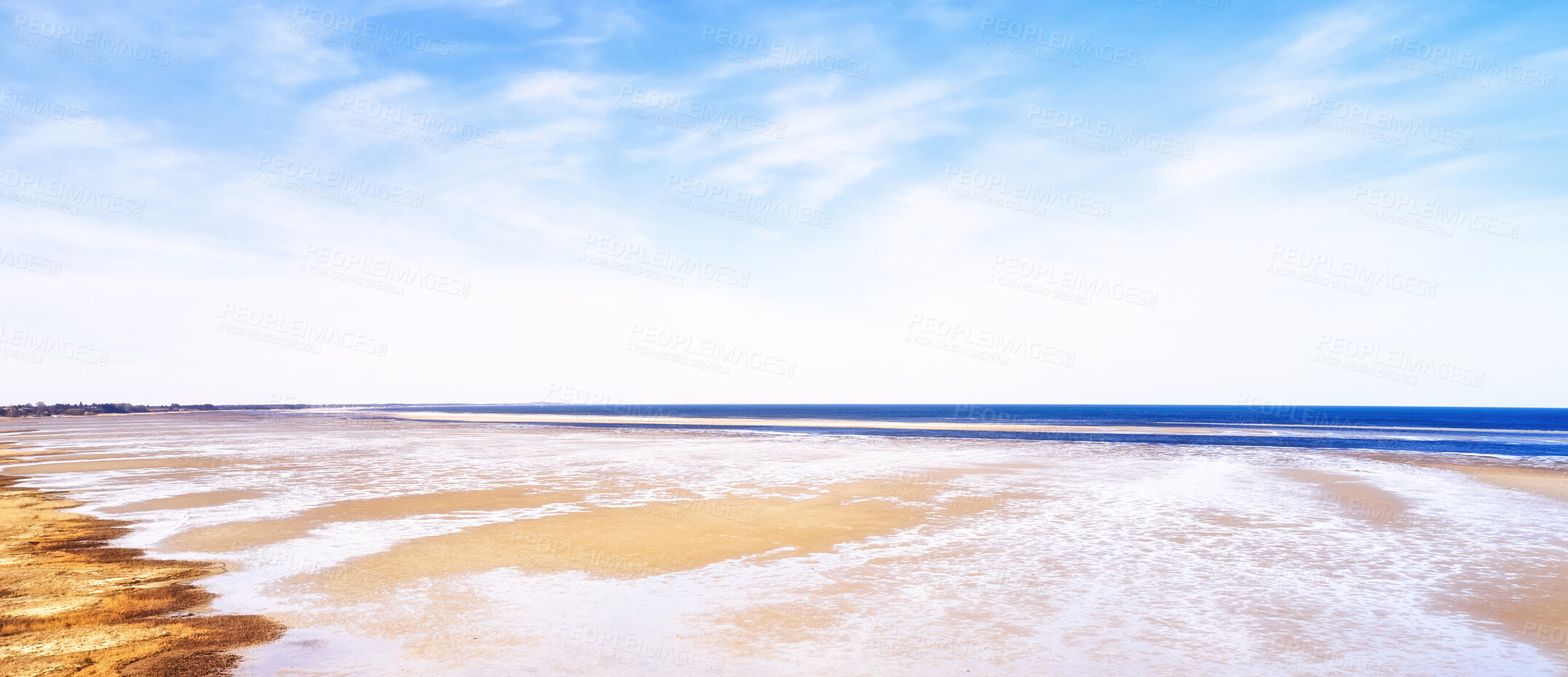 Buy stock photo Beautiful landscape scenic view of the beach and water against a cloudy blue sky in summer. Copyspace and banner view of the seaside and ocean. Natural environment of the sea with copy space