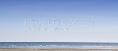 Buy stock photo Copy space at the sea with a clear blue sky background above the horizon. Panoramic of calm ocean waters across a beach shore. Peaceful scenic coastal landscape for a relaxing and zen summer getaway