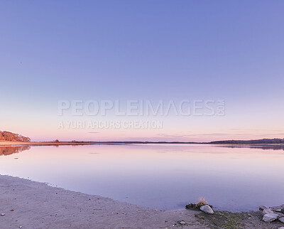 Buy stock photo Beautiful landscape banner view of the ocean on the coast against a pink sunset in the sky in summer. Relaxing copyspace view of the calm sea water and beach at the seashore along the coastline