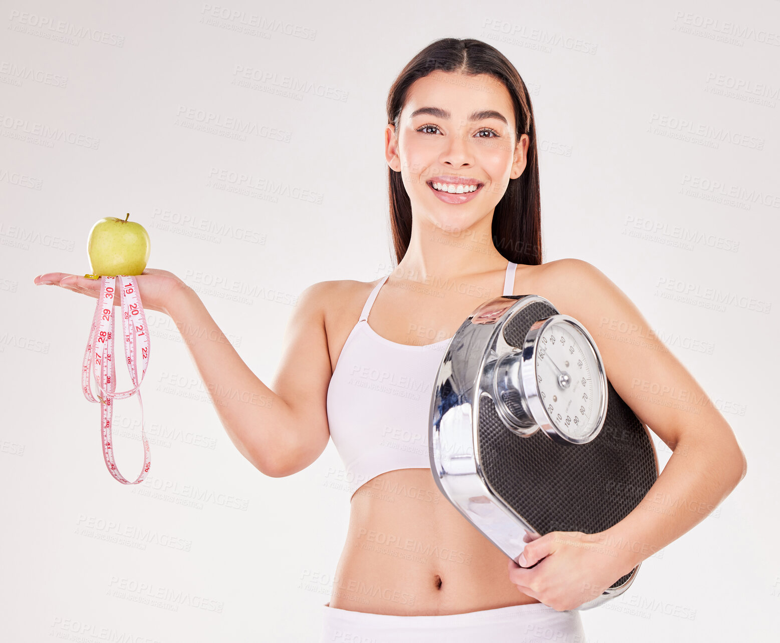 Buy stock photo Portrait, tape measure or girl with apple or scale for healthy snack, nutrition diet or digestion benefits. Happy woman, lose weight or fitness model with smile or fruit in studio on white background