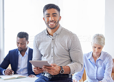 Buy stock photo Shot of a confident young businessman working in a modern office