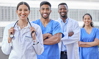 Buy stock photo Shot of a group of doctors standing against a city background